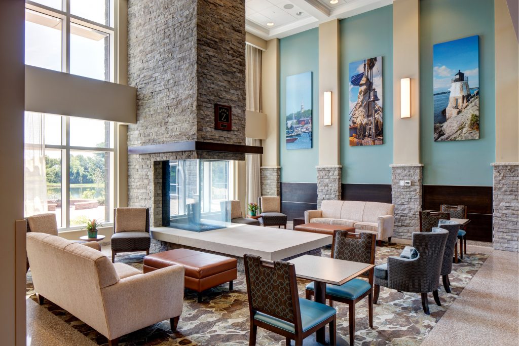 Hotel Lobby with Fireplace and Coastal Photos
