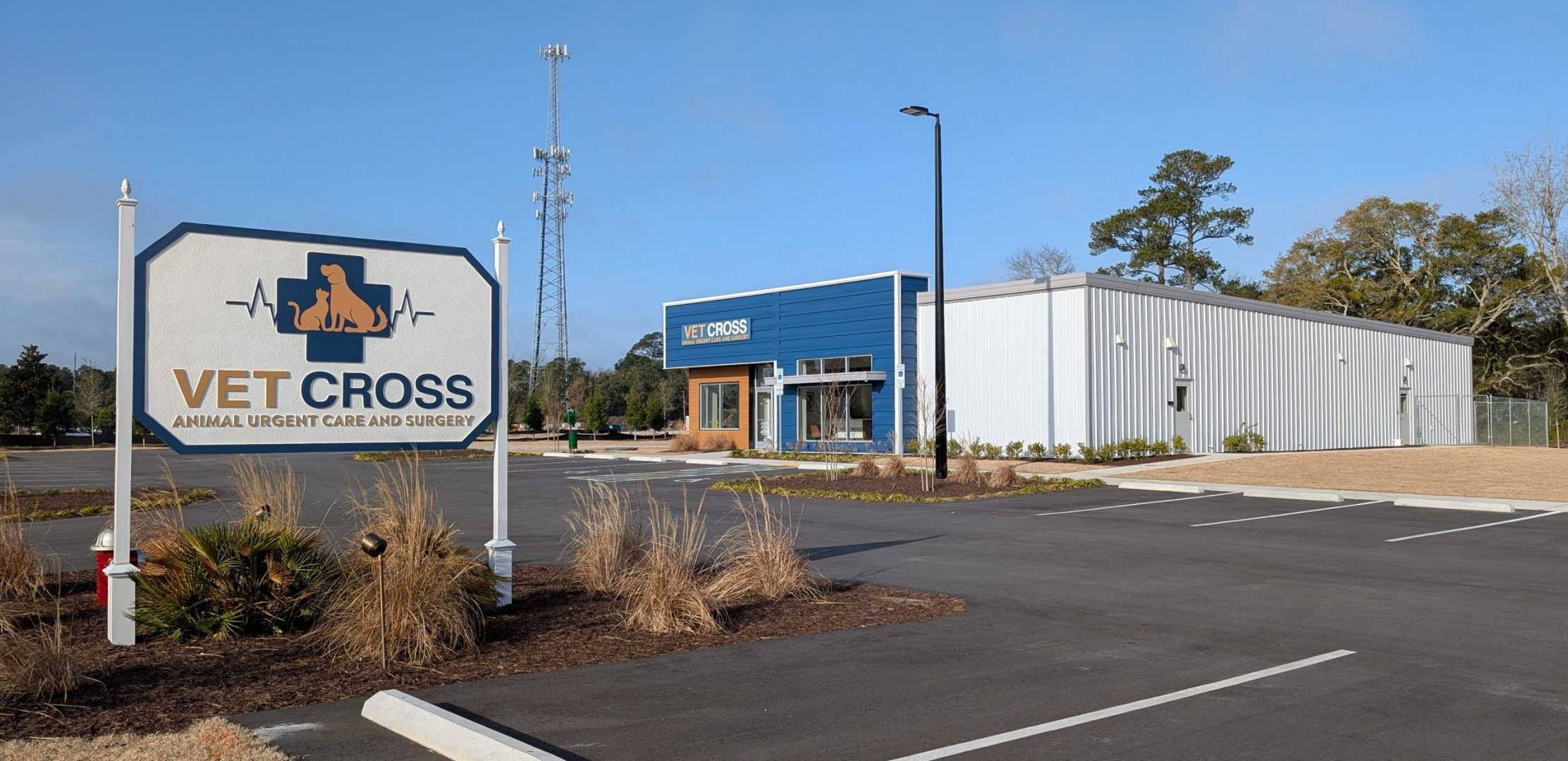 Sign that reads Vet Cross with building in the background