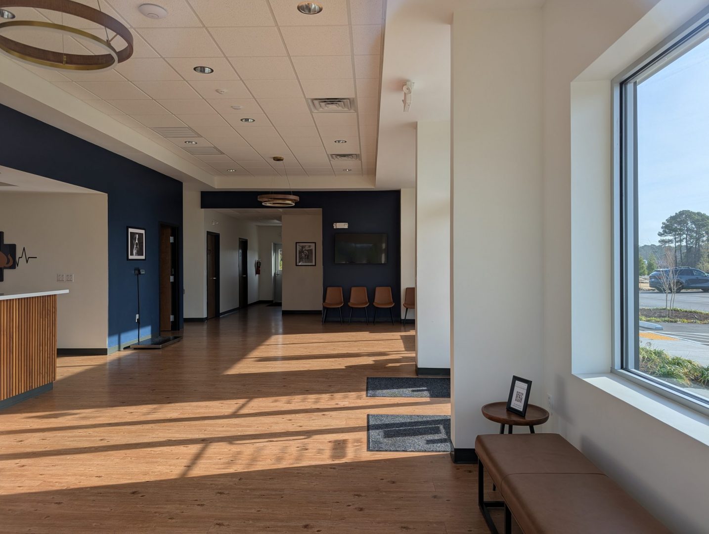 Interior waiting room with blue accent wall and leather furniture