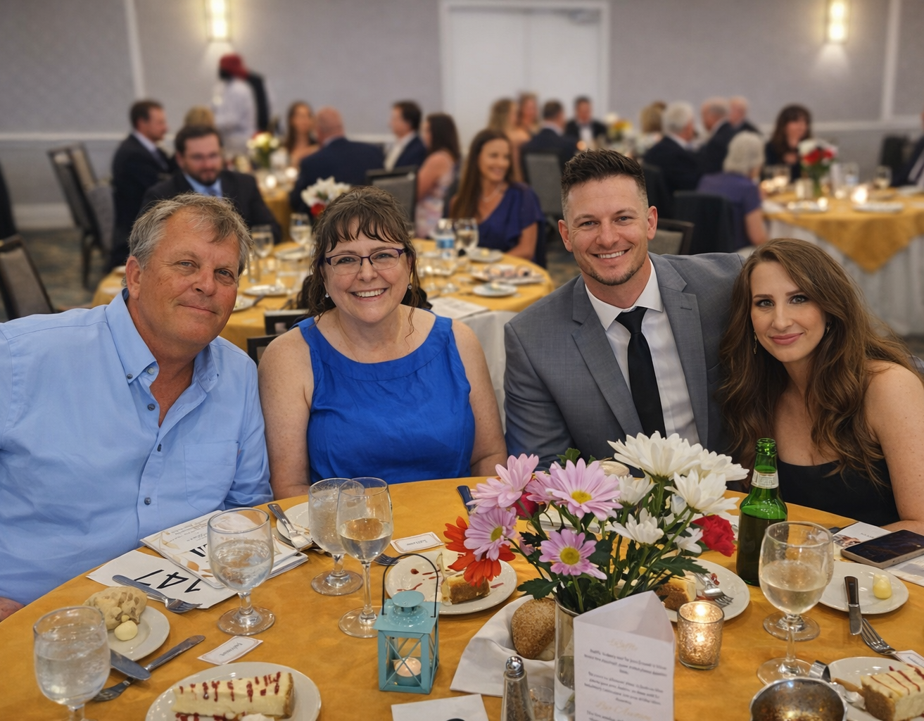 A group of 4 people pose at a table